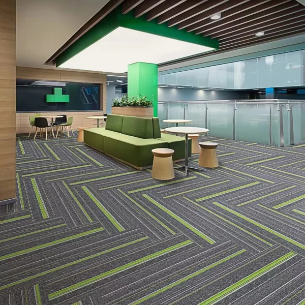 Gray-green cut pile carpet tile in herringbone pattern.