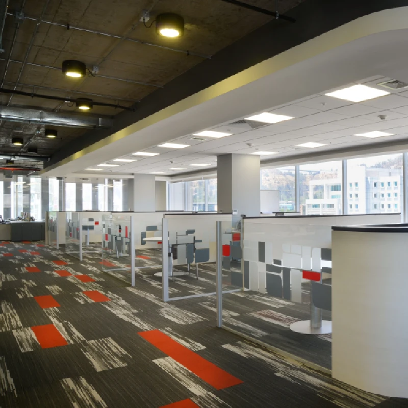 Modern grey abstract carpet with red accents in a corporate office.