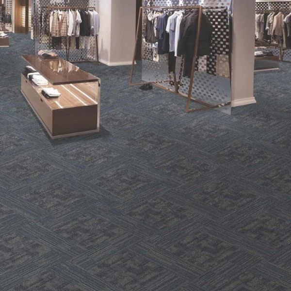 Modern grey and yellow geometric carpet tiles in a workspace.