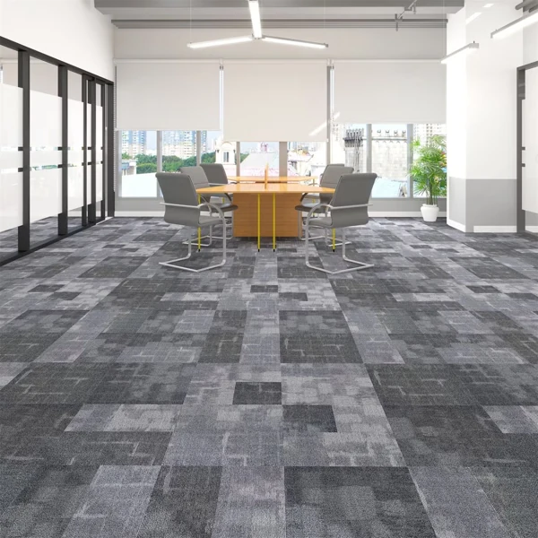 Modern grey patterned carpet tiles in a bright office.