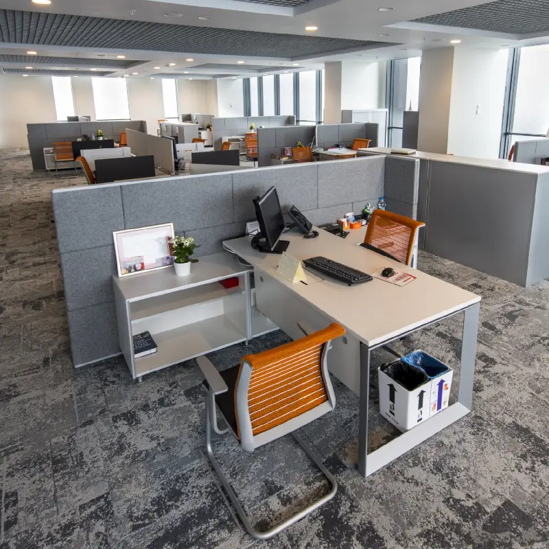 Modern grey textured carpet tiles in a contemporary office cubicle.