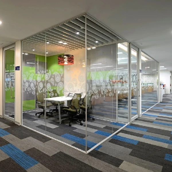 Modern linear carpet tiles with blue and grey accents in a glass-walled meeting room.