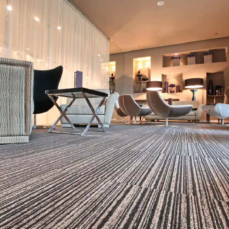 Modern linear grey carpet in a luxury office lounge area.