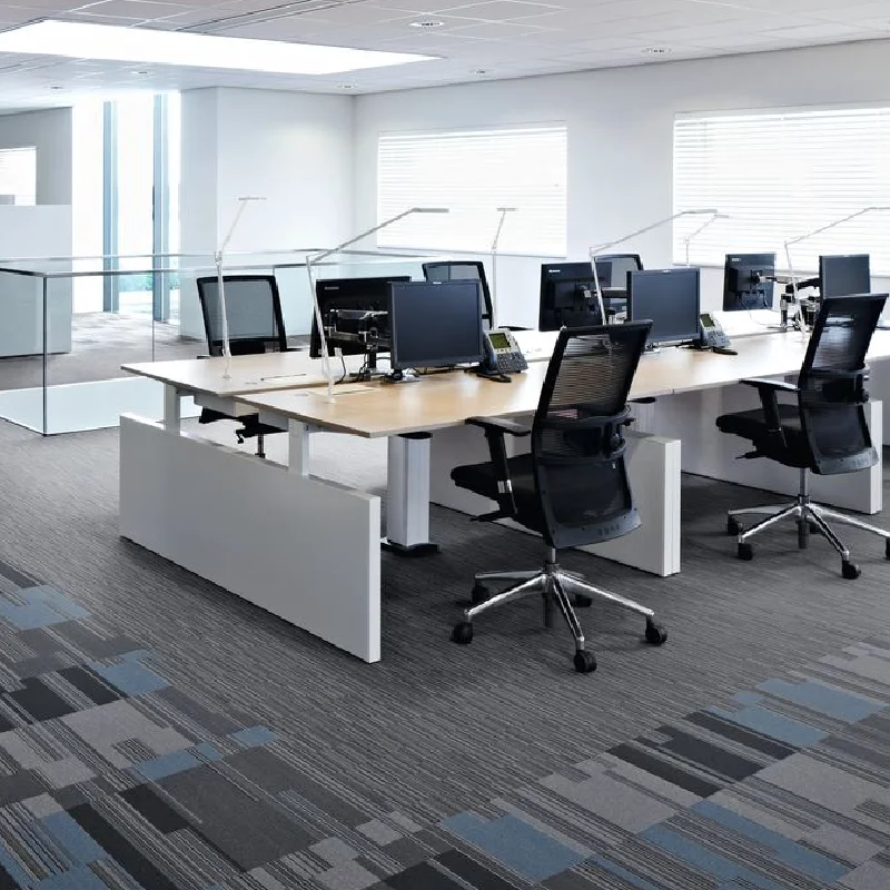 Modern linear grey carpet tiles in a bright, open-plan office.