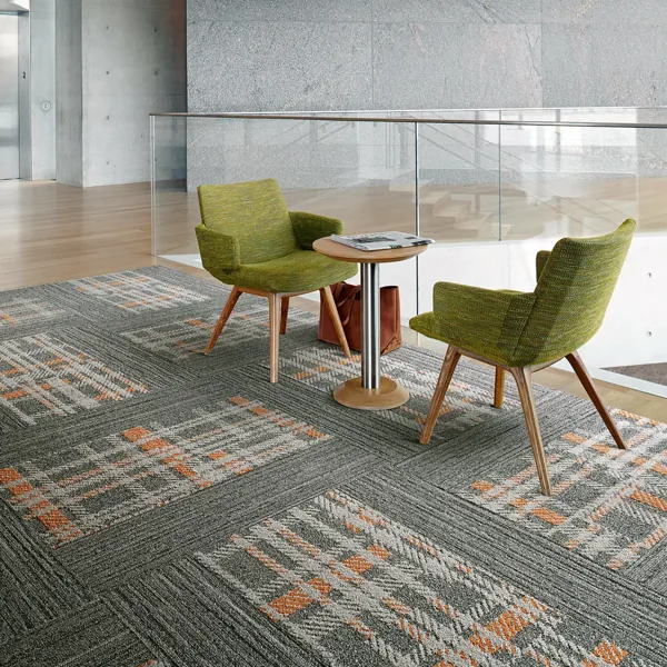 Textured woven carpet tiles in grey and orange patterns.