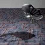 carpet tiles with navy, rust, and gray installed in modern office